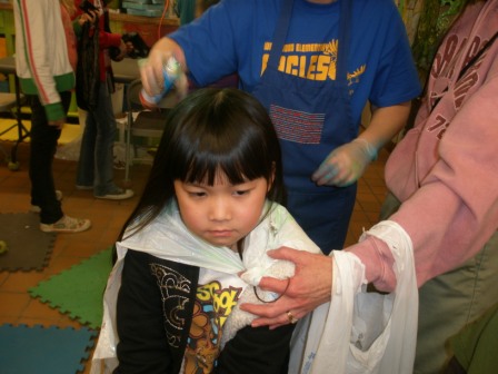 Kasen getting hair painted at Winterfest
